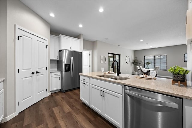 kitchen with sink, white cabinets, and appliances with stainless steel finishes