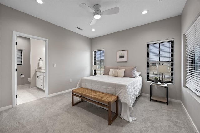 carpeted bedroom with connected bathroom and ceiling fan