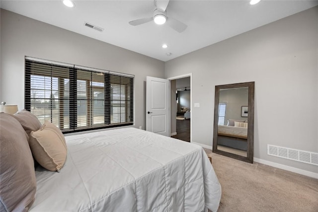 carpeted bedroom with multiple windows and ceiling fan