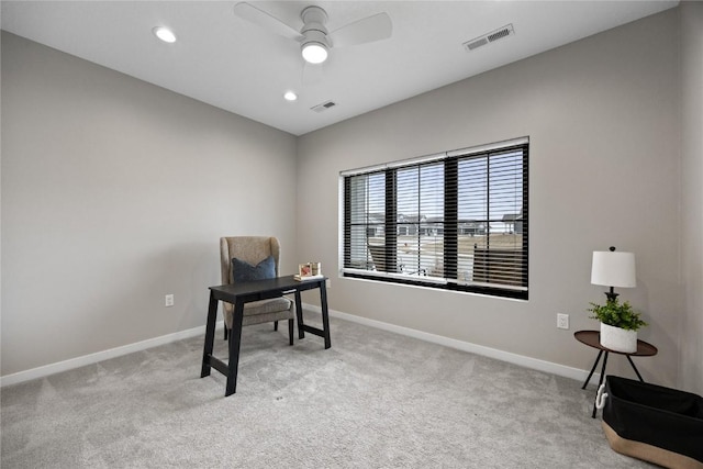 home office featuring ceiling fan and light carpet