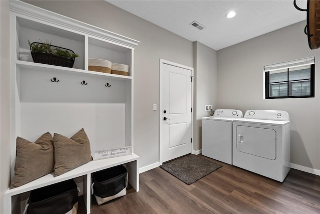 laundry area with washing machine and dryer and dark wood-type flooring