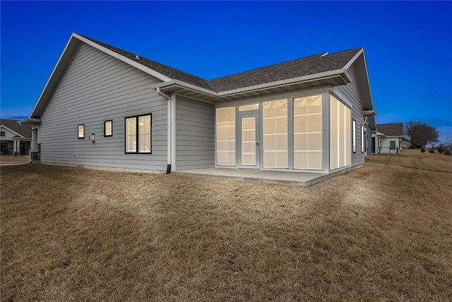 back of property featuring a yard and a patio area