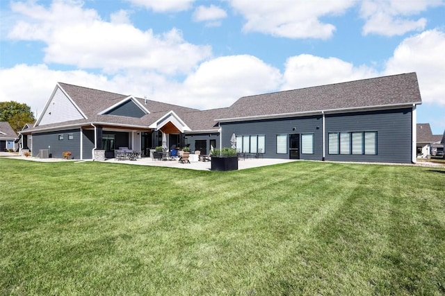 back of house with a patio area and a lawn