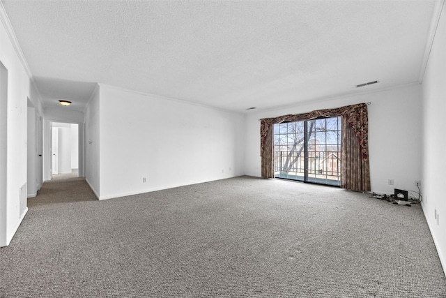 carpeted empty room featuring ornamental molding and a textured ceiling