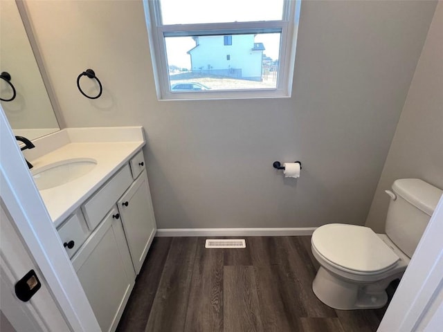 bathroom with vanity, hardwood / wood-style floors, and toilet