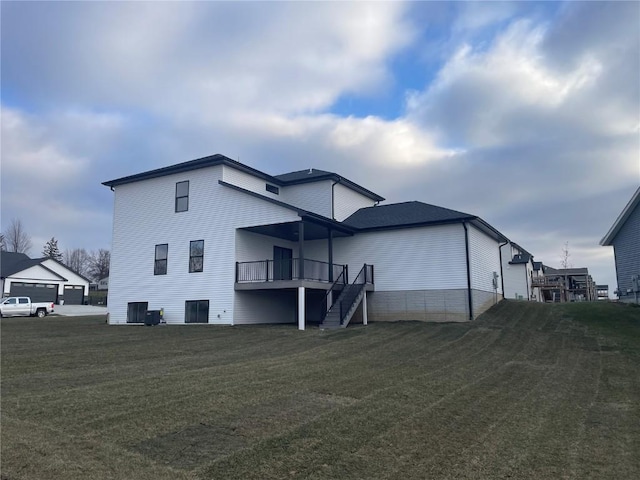 rear view of property featuring a lawn