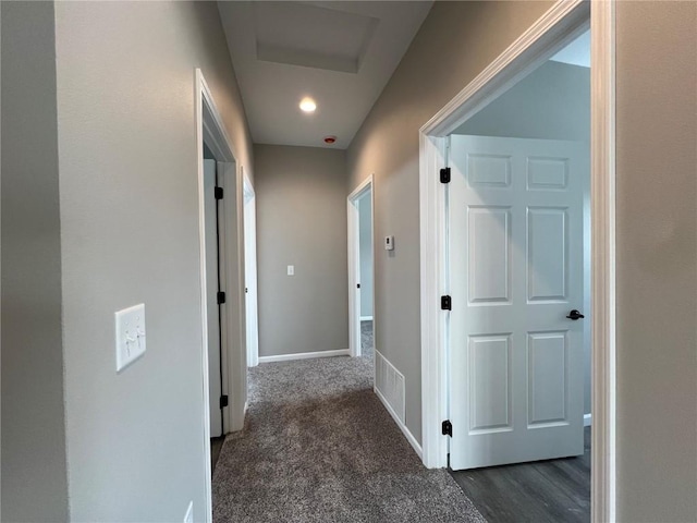 corridor with dark colored carpet