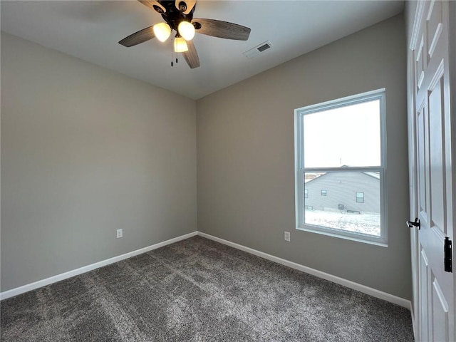 empty room featuring carpet floors and ceiling fan