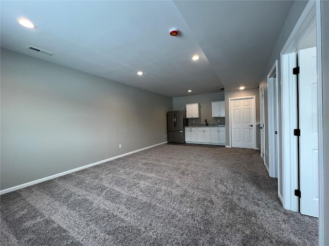 unfurnished living room featuring carpet