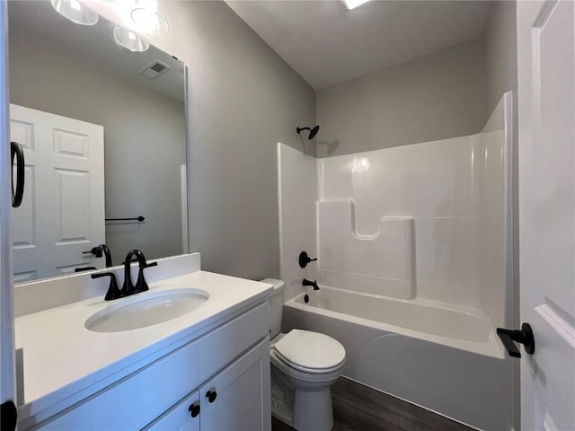 full bathroom featuring vanity, toilet, tub / shower combination, and hardwood / wood-style floors