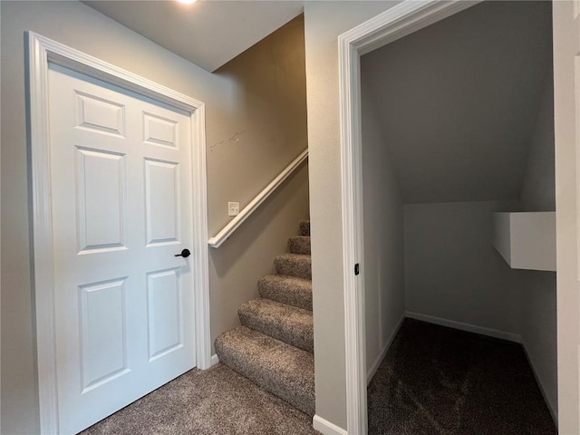 staircase with vaulted ceiling and carpet floors