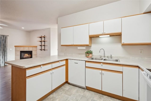 kitchen featuring sink, white cabinets, white appliances, and kitchen peninsula