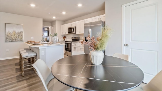 dining area with dark wood-type flooring and sink