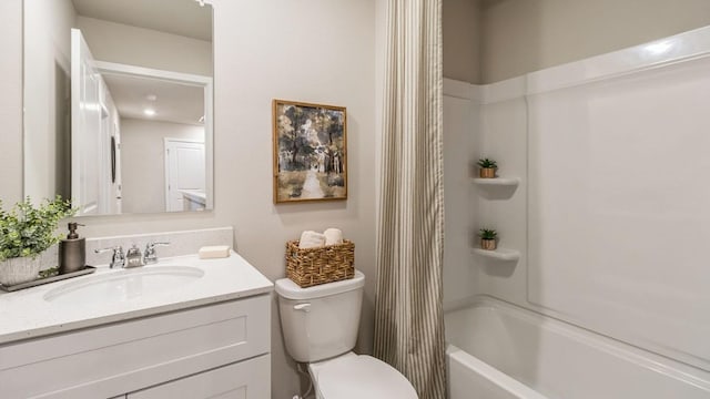 full bathroom featuring shower / bath combination with curtain, vanity, and toilet