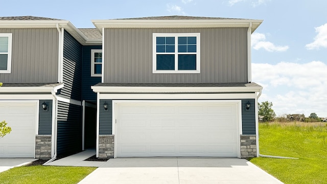 view of front of home with a garage and a front lawn