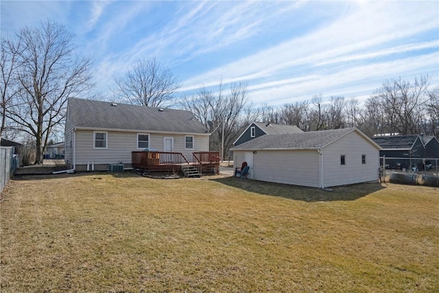 back of property featuring a deck, central air condition unit, and a lawn