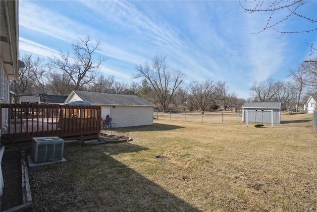 view of yard featuring a shed, central AC unit, and a deck