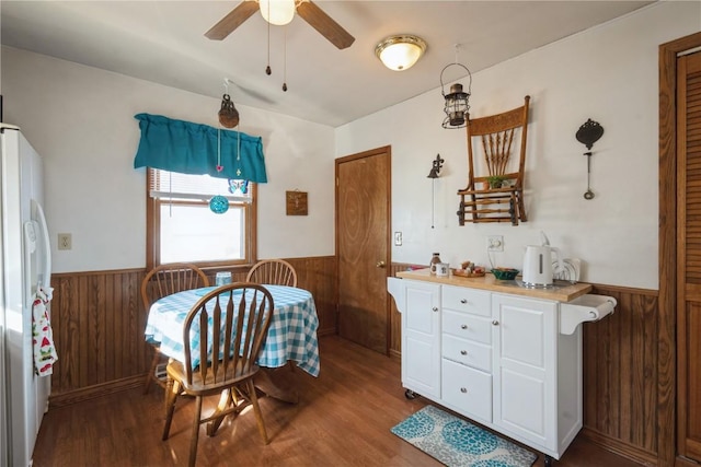 kitchen featuring white cabinetry, butcher block counters, wooden walls, wood-type flooring, and white fridge with ice dispenser