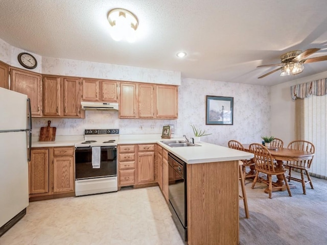 kitchen featuring sink, white appliances, ceiling fan, a textured ceiling, and kitchen peninsula