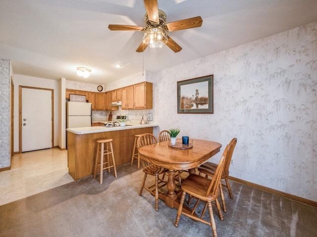 dining room featuring carpet and ceiling fan