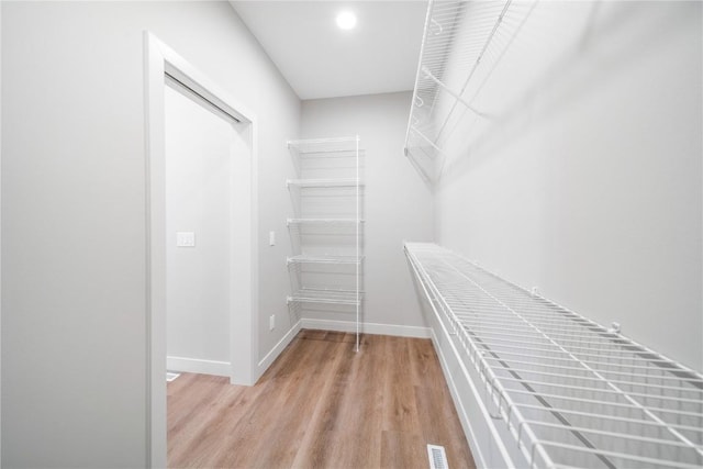 walk in closet featuring light hardwood / wood-style flooring