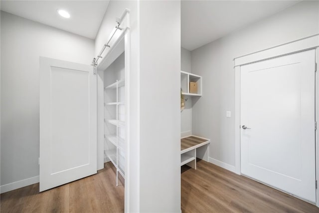 mudroom featuring a barn door and hardwood / wood-style floors