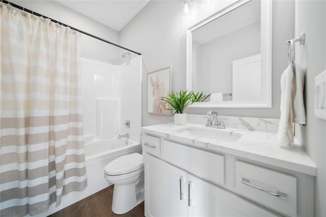 full bathroom with vanity, hardwood / wood-style floors, shower / bath combination with curtain, and toilet