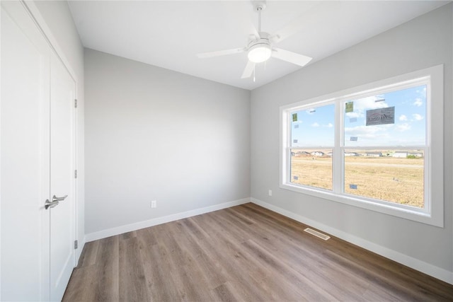 unfurnished bedroom featuring light hardwood / wood-style flooring, a closet, and ceiling fan