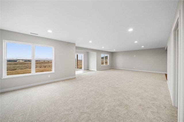 unfurnished room featuring light colored carpet