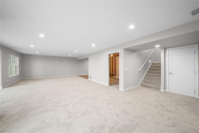 basement featuring light carpet