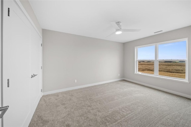 empty room with carpet flooring and ceiling fan