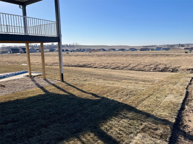 view of yard with a rural view