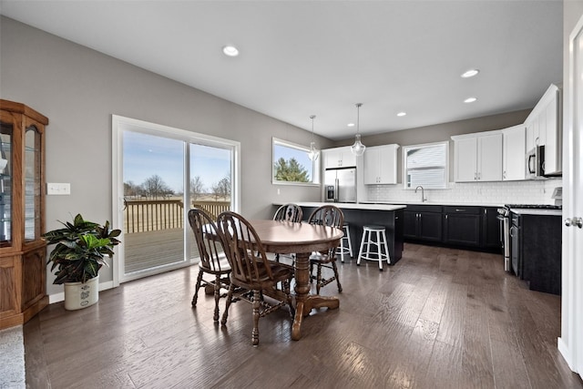 dining space with dark wood-type flooring and sink