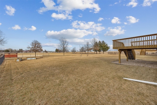 view of yard featuring a wooden deck and a rural view