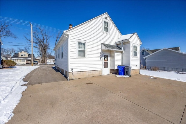 rear view of property with a chimney