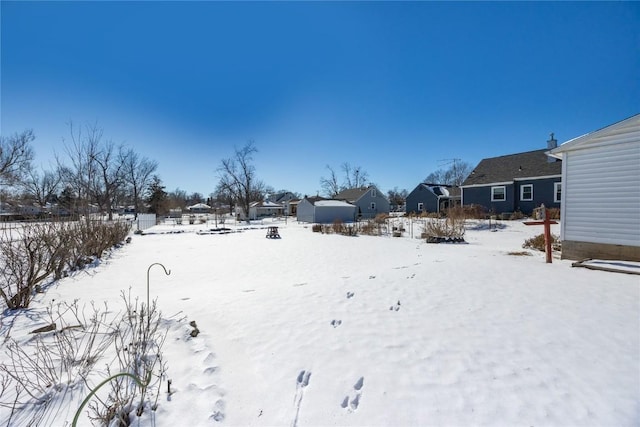 snowy yard with a residential view