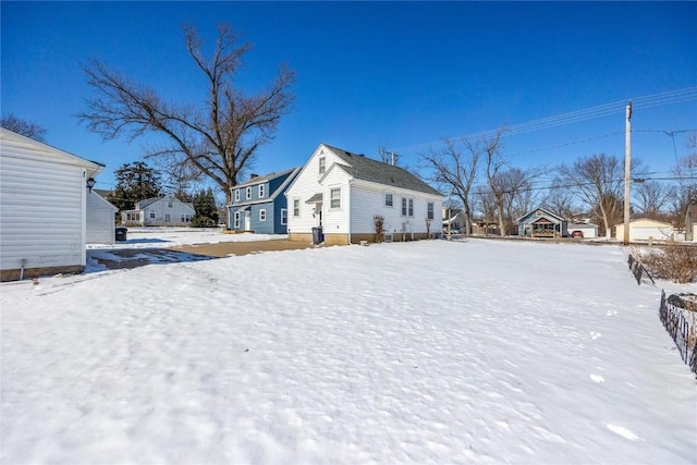 yard covered in snow with a residential view