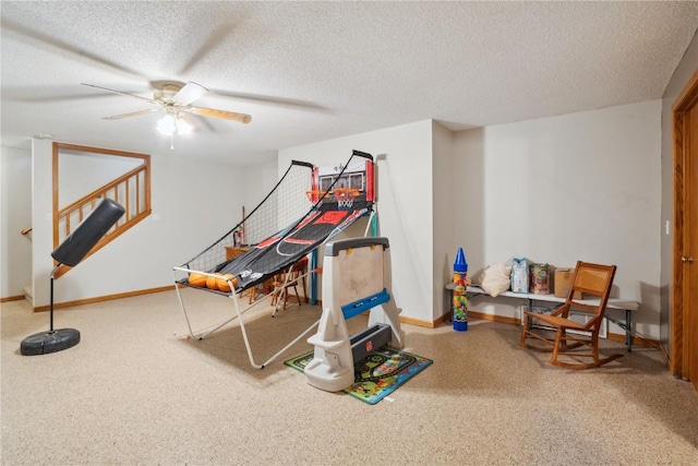 rec room featuring ceiling fan and a textured ceiling