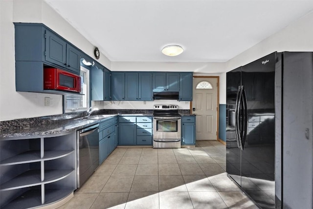 kitchen featuring light tile patterned flooring, appliances with stainless steel finishes, blue cabinets, and sink