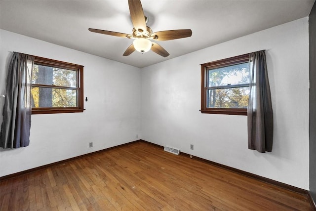 spare room featuring hardwood / wood-style flooring and ceiling fan