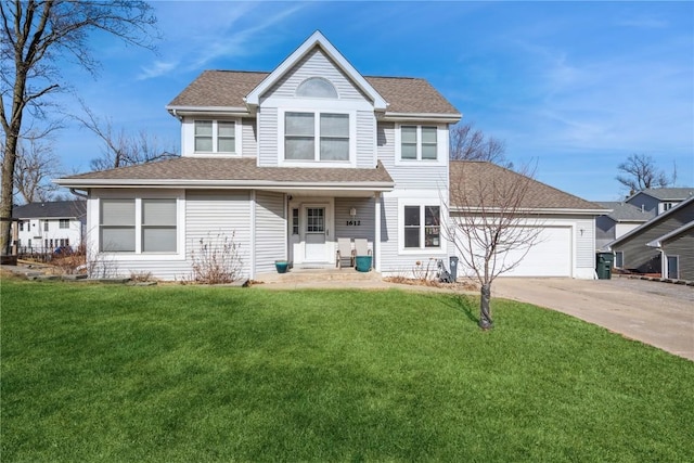 view of front of property featuring a garage and a front lawn