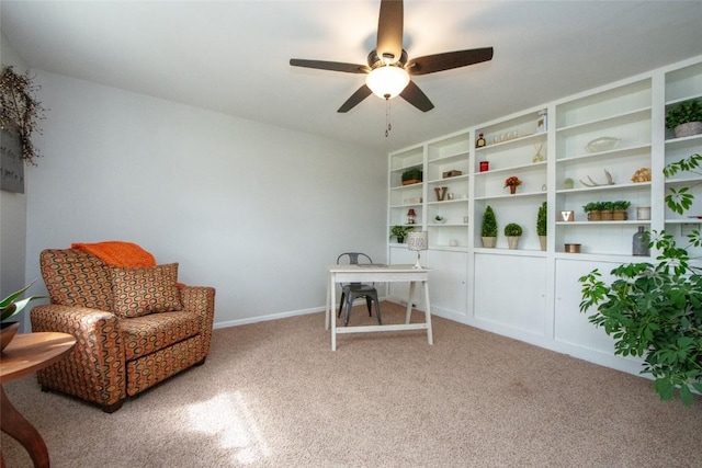 living area featuring ceiling fan and carpet flooring