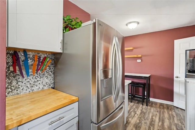 kitchen featuring butcher block counters, white cabinetry, dark wood-type flooring, and stainless steel fridge with ice dispenser