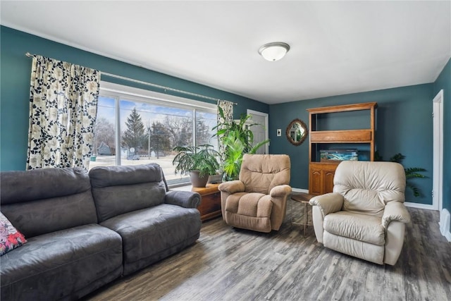 living area featuring baseboards and wood finished floors