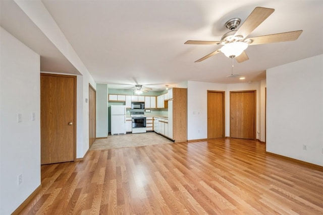 unfurnished living room featuring ceiling fan and light hardwood / wood-style floors