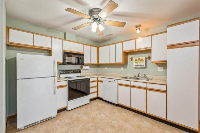 kitchen with sink, white cabinets, and white appliances