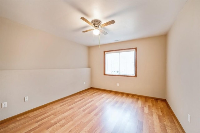 spare room with ceiling fan and light wood-type flooring