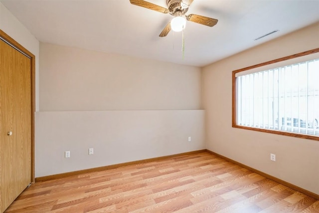 unfurnished bedroom featuring a closet, ceiling fan, and light wood-type flooring