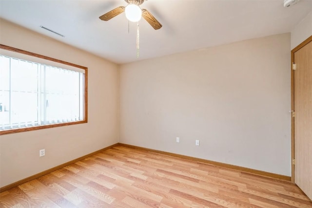 empty room with light hardwood / wood-style floors and ceiling fan