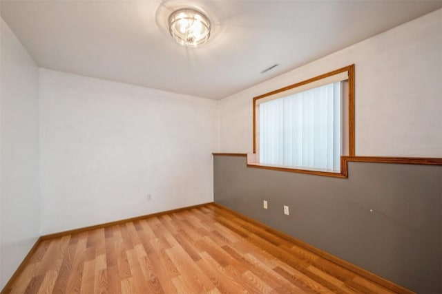 spare room with light hardwood / wood-style floors